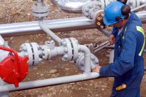 Field worker preparing pipeline for hydrostatic testing with hydrostatic testing corrosion inhibitor.