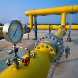 Close-up of pipeline with water pressure gauge using hydrostatic testing corrosion inhibitor.