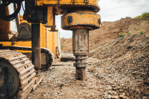 Rotary drill operating at a mining site, addressing mining corrosion challenges.